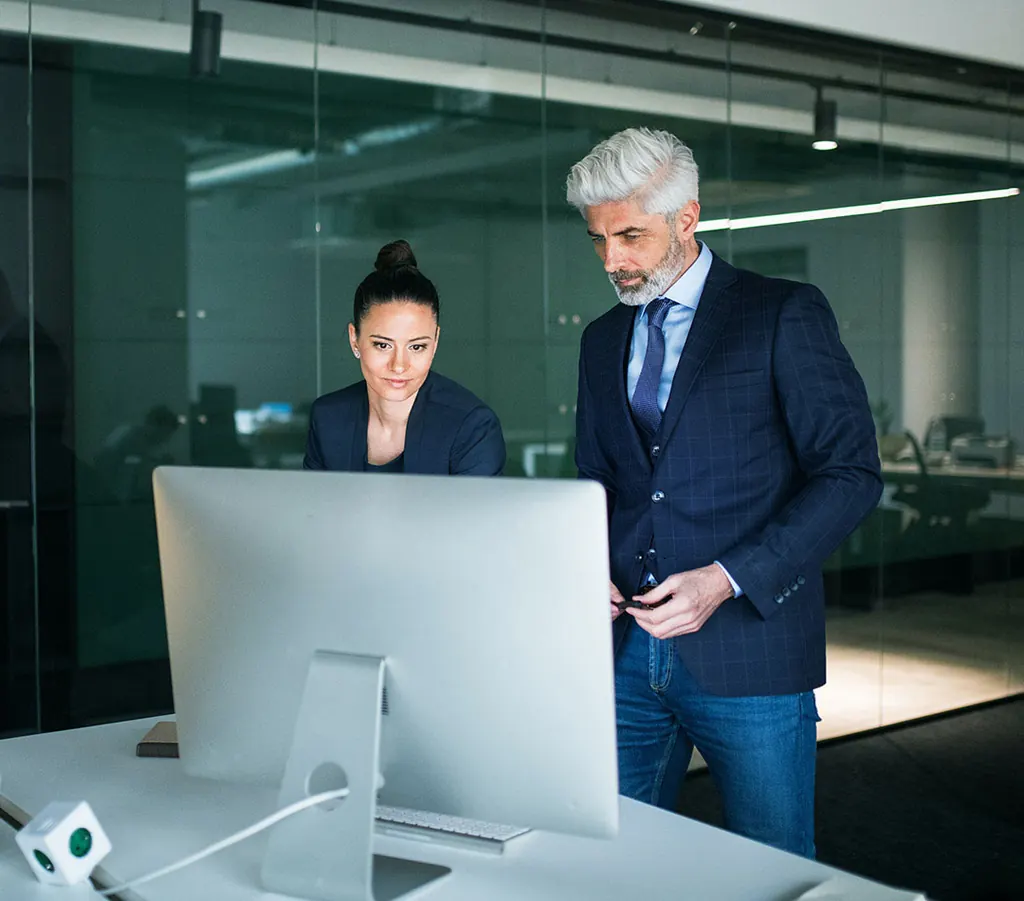 Two equity release advisers reviewing a plan together